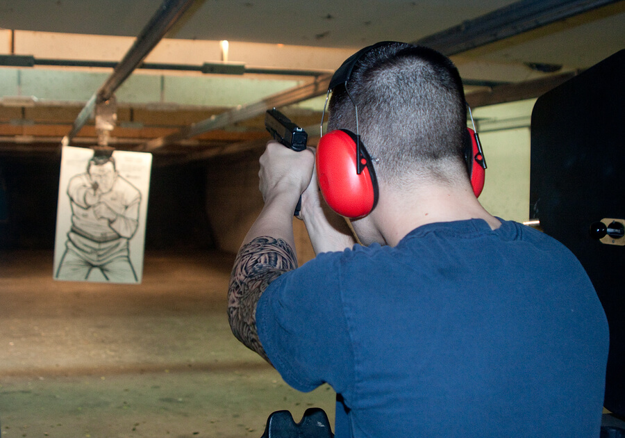 Picture of a felon at a shooting range.