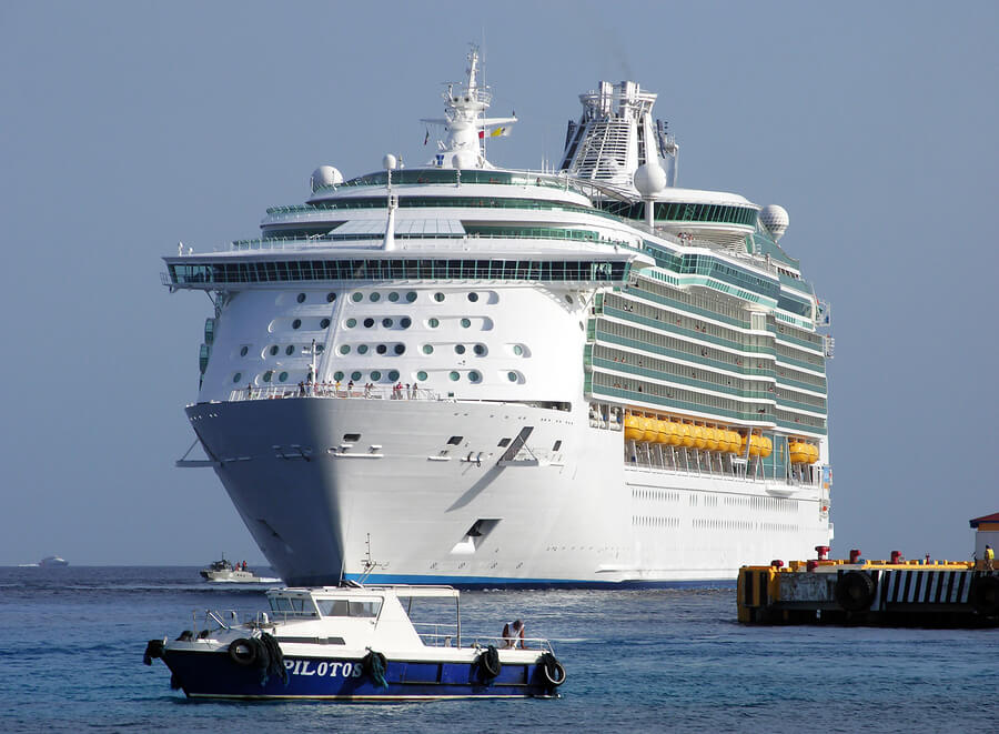 Picture of a cruise ship arriving at a port in a foreign country.